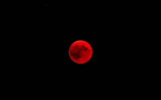 Красная луна на черном фоне
