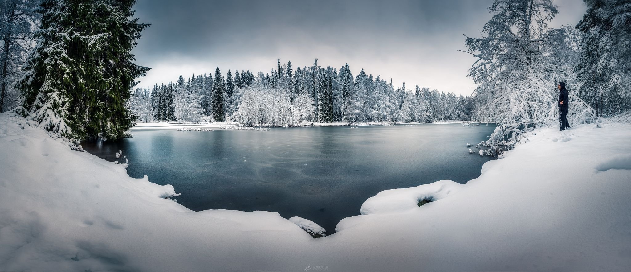 Замерзшее озеро в лесу зимой